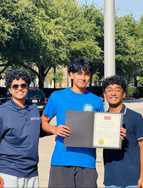 STEMSeeds founders holding a City of Frisco certificate of recognition